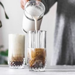 Close-up of coffee being poured into cup on table