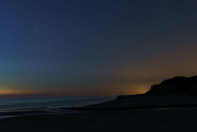 Scenic view of sea against sky at night