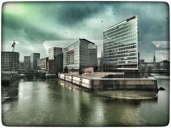 View of cityscape against cloudy sky