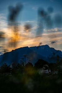 Scenic view of mountains against sky at sunset