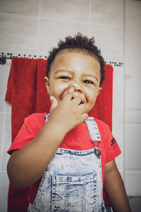 Smiling boy picking nose