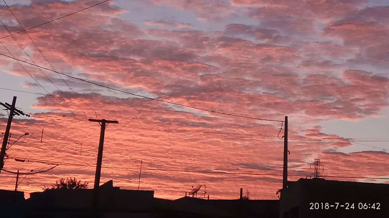 LOW ANGLE VIEW OF SILHOUETTE ELECTRICITY PYLON AGAINST DRAMATIC SKY