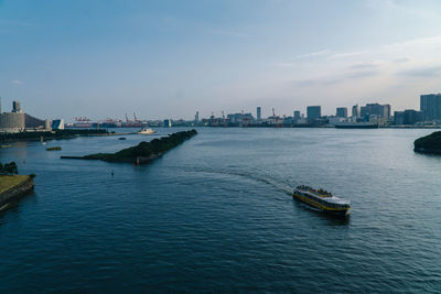 Scenic view of sea and buildings against sky