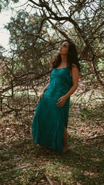 Portrait of young woman standing in forest