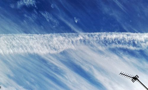 Low angle view of airplane flying against sky