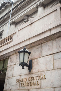 Low angle view of street light against building