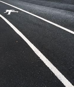 High angle view of pedestrian crossing sign on road