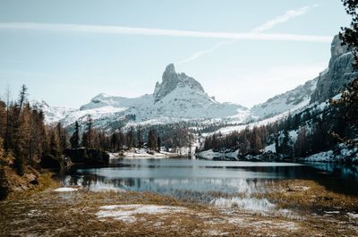 Scenic view of lake and snowcapped mountains against sky