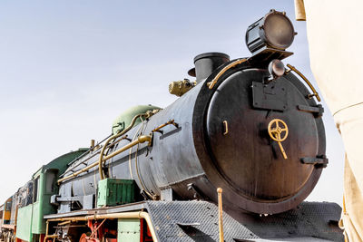 Low angle view of locomotive train against sky