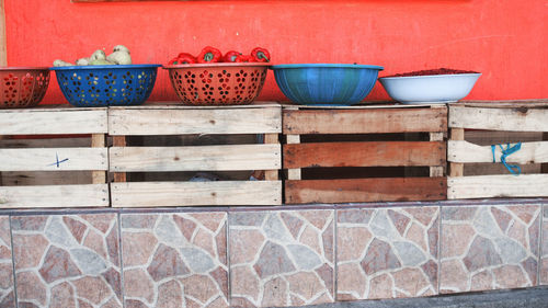 Containers on wooden crates against wall
