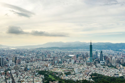 High angle view of city against cloudy sky