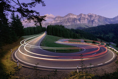 High angle view of light trails on road against sky