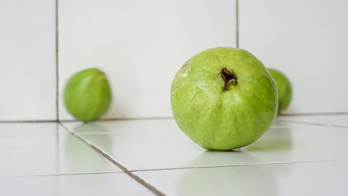 Close-up of apple on green table
