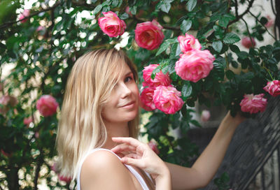 Portrait of woman with pink flowers