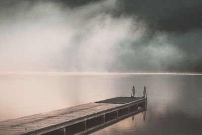 Pier over lake against sky