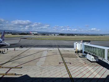 Airplane on runway against sky