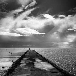 Pier over sea against sky