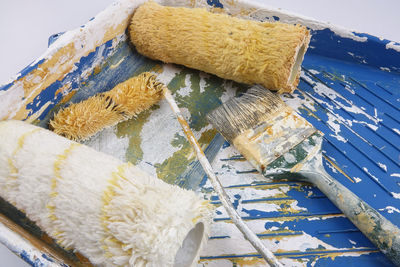 Close-up of paintbrush and roller