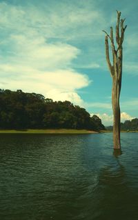 Scenic view of lake against cloudy sky