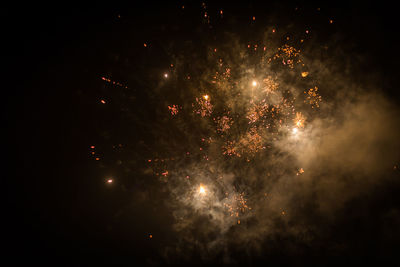 Low angle view of firework display at night