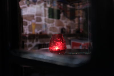 Close-up of illuminated lamp on table