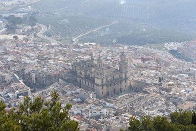 Aerial view of historic building amidst cityscape during sunny day