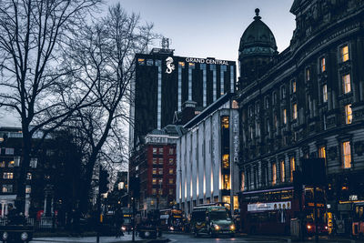 Illuminated buildings in city at dusk