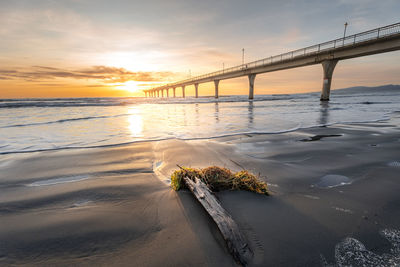 Beautiful sunrise over the new brighton pier at christchurch, new zealand.