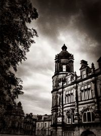 Low angle view of building against cloudy sky