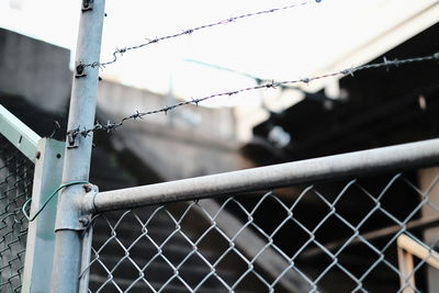 Close-up of chainlink fence against sky