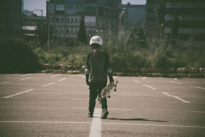 Rear view of boy on zebra crossing