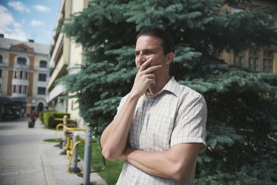 Portrait of man standing in city