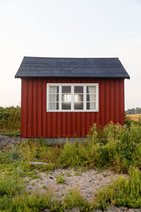 Exterior of house on field against sky