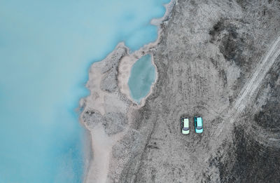 Aerial view of cars by the lake