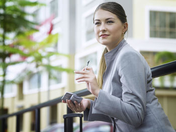 Close-up of businesswoman using mobile phone