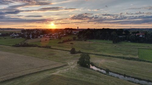 Scenic view of field against sky during sunset