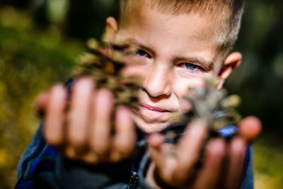 Portrait of boy holding outdoors