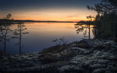 Scenic view of lake against sky at sunset