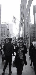 People walking on road along buildings