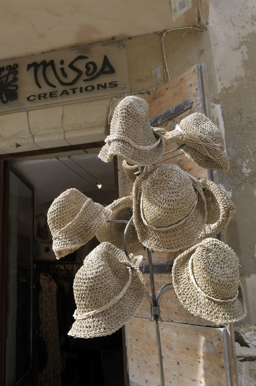 LOW ANGLE VIEW OF DECORATIONS HANGING ON WALL