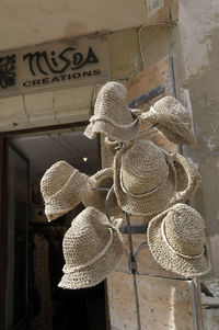 Low angle view of hat hanging against wall