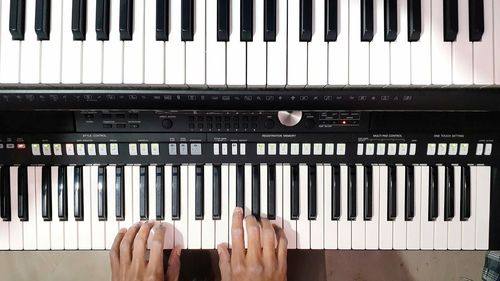 Low section of woman playing piano