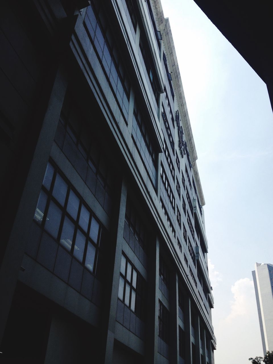 architecture, low angle view, built structure, sky, building, city, office building, modern, no people, day, outdoors, tall - high, directly below, cloud, city life, architectural feature, tall, cloud - sky, nature