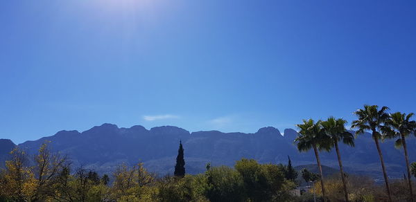 Scenic view of mountains against clear blue sky