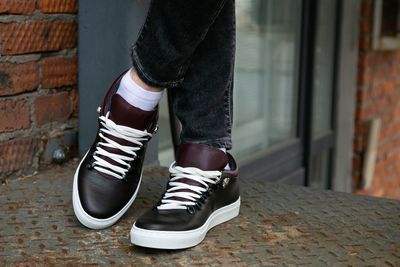 Low section of man standing on footpath