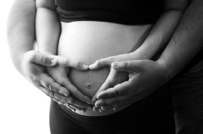 Midsection of woman with baby hand