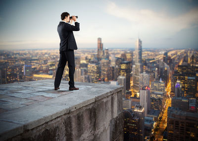 Full length of man standing in city against sky