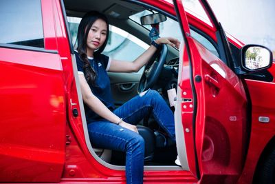 Portrait of smiling woman sitting in car