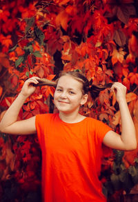 Low angle view of child standing on autumn leaves