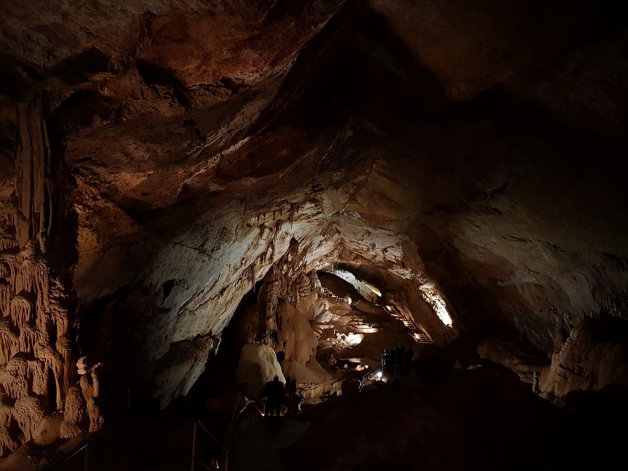 cave, stalactite, rock formation, rock, geology, rock - object, physical geography, indoors, no people, solid, natural pattern, beauty in nature, low angle view, rough, nature, textured, tranquility, illuminated, pattern, eroded